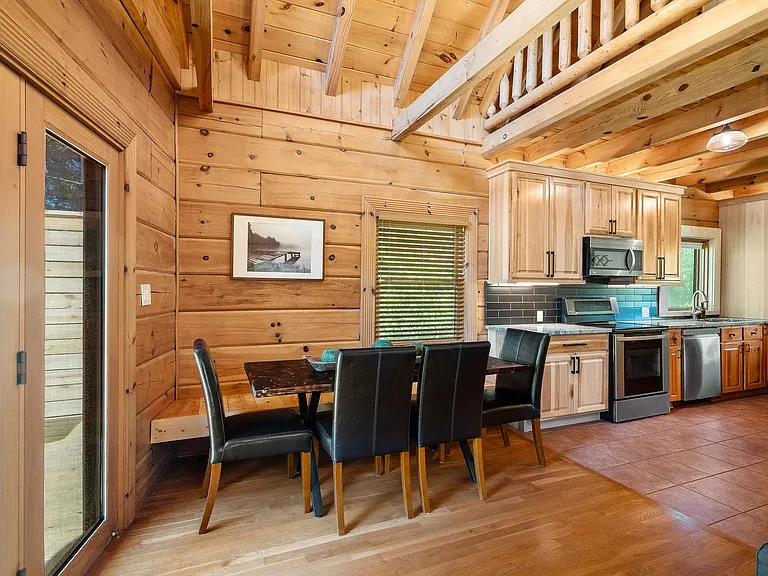 Dining area off of the kitchen and family room. Includes a built-in wooden bench for extra seating.