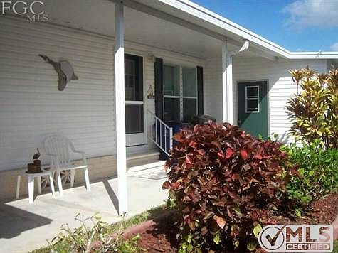 Side entrance and attached storage room.