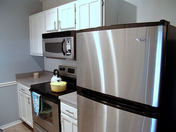Kitchen with stainless steel refrigerator