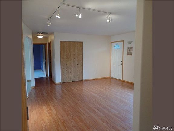 Ample living room with nice lighting and laminate floors