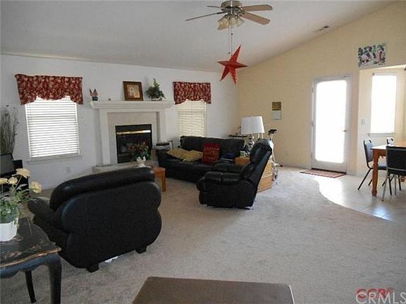 The spacious family room features a lovely fireplace, dining area and a private patio just outside the door.
