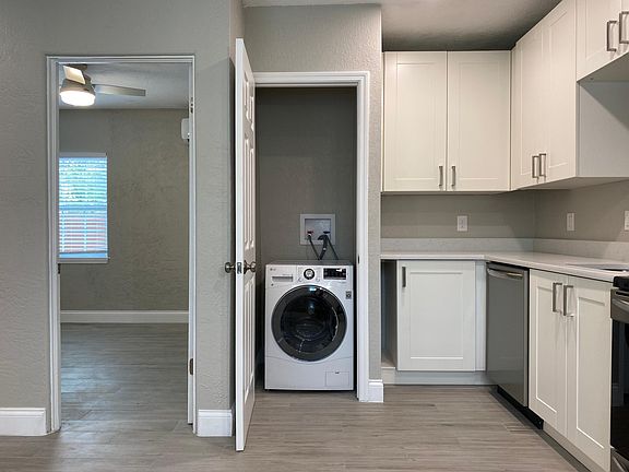 Bedroom on the left, washer/dryer combo, kitchen on the right.