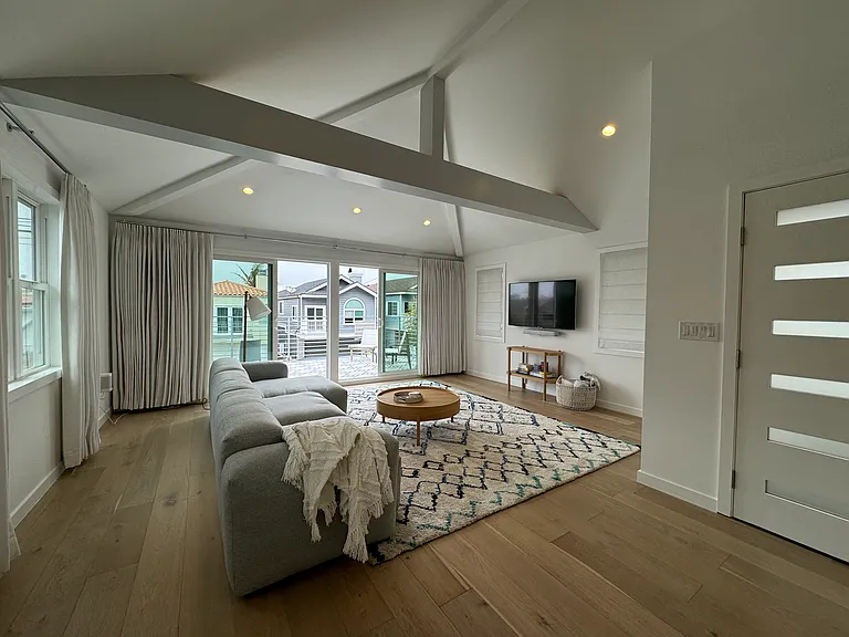 Enter into the open concept living room/dining/kitchen. TV with Sonos soundbar and speakers included. Custom window coverings throughout.