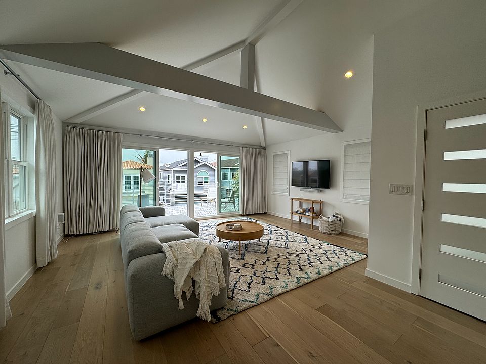 Enter into the open concept living room/dining/kitchen. TV with Sonos soundbar and speakers included. Custom window coverings throughout.