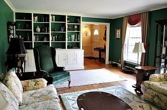 Built-in shelving and cabinets on one wall of LR