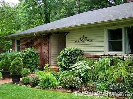 Front door, beds, & wrought iron detail