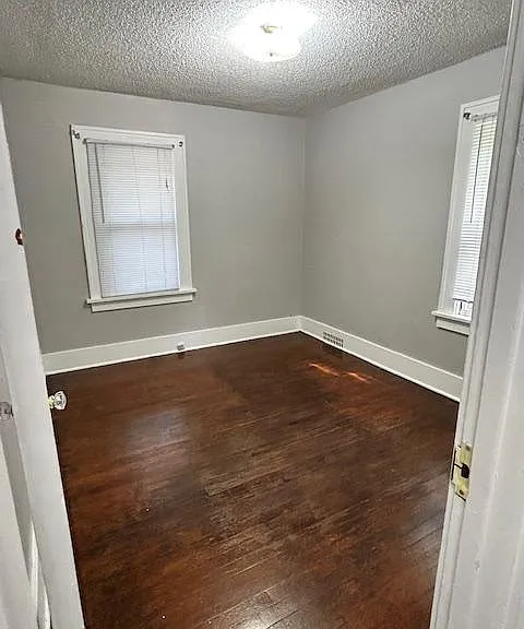 Bedroom #1. On the east side of the house. More shaded and smallest of the rooms. Hardwood floors.