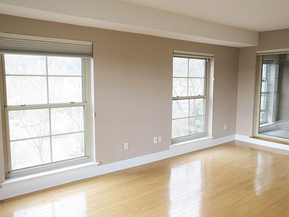 From the master bedroom, a doorway leads to the west-facing balcony with views over Piermont village towards South Mountain.