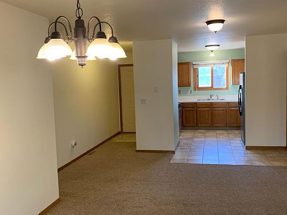 A second view from the dining area into the kitchen/entry.