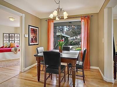 Formal dining room with large picture window looks onto the lovely landscaping