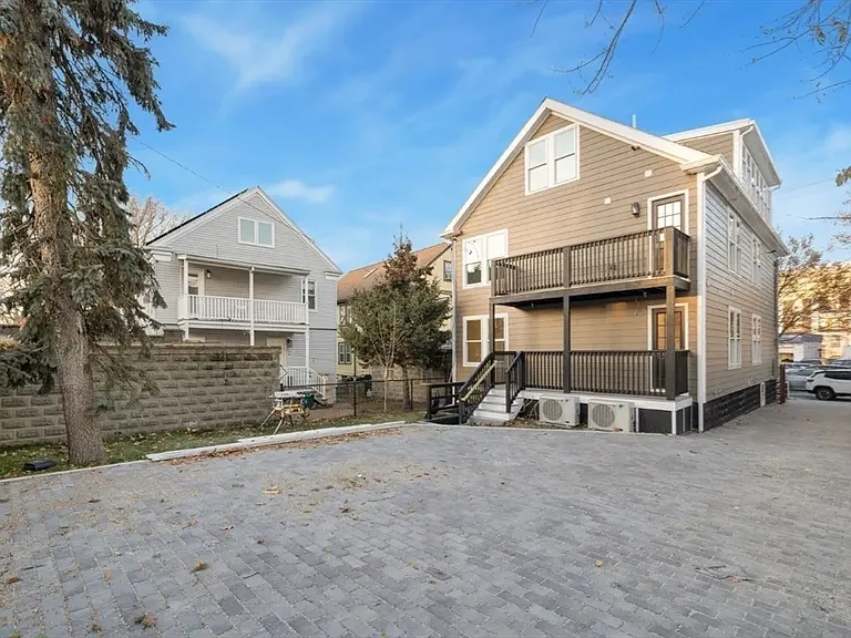 Quiet retreat: The rear exterior highlights the private green space and easy access to your parking spot and a back porch