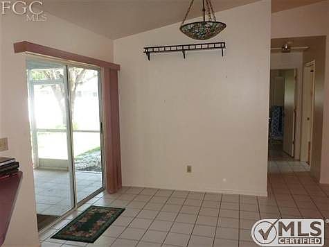 Dining area in the end of the Family Room with slider to the lanai.