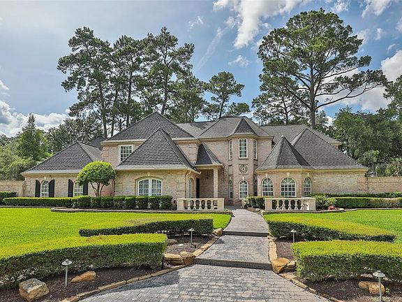 A charming walkway leading to this majestic beauty outlined by a custom brick design and lush landscape is sure to greet your guests in style.
