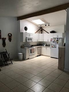 Kitchen offers updated cabinets and appliances with natural