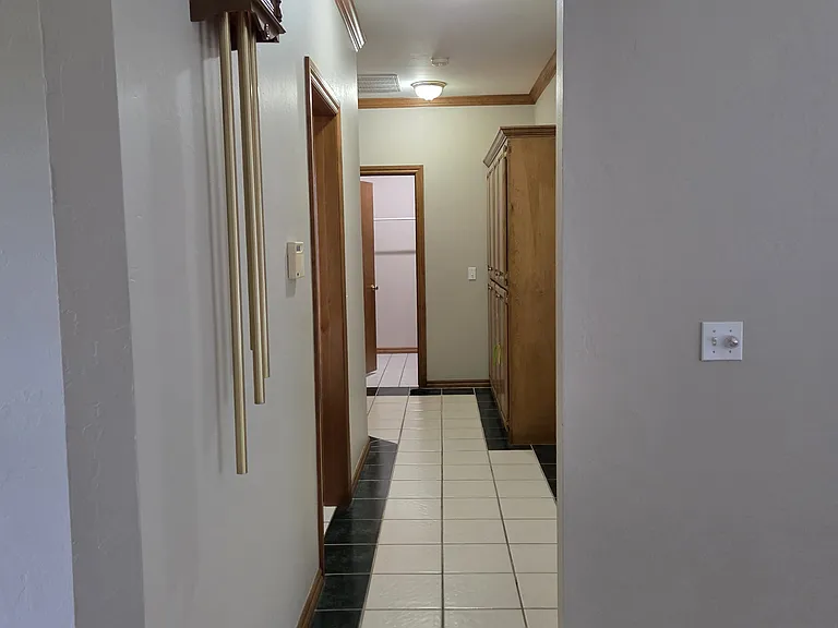 Hallway From Entry to Master Bed, Kitchen, and Garage