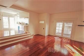 Front entry with elevated kitchen and dining area at photo left