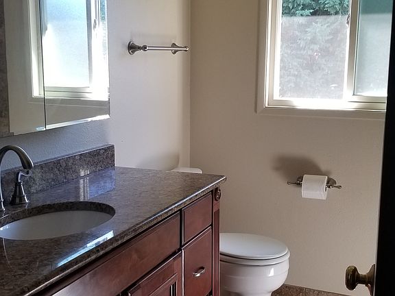 Full bathroom, granite countertops, modern windows
