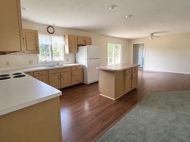 Kitchen has island and opens to greatroom. Also sliders to small deck to backyard. Garage entry into kitchen/dining area