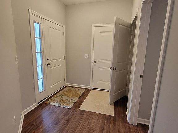 Foyer with front door, garage door, hallway closet and entry to laundry