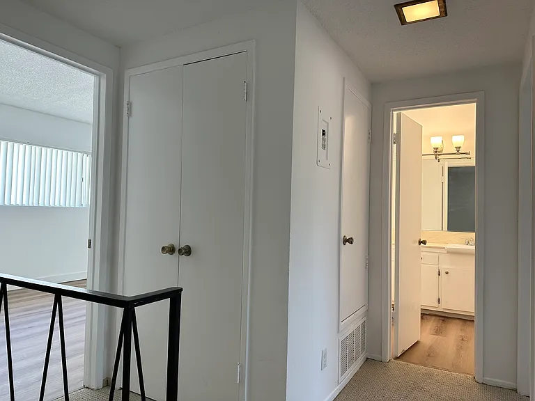 Upstair landing with linen closet and full bathroom