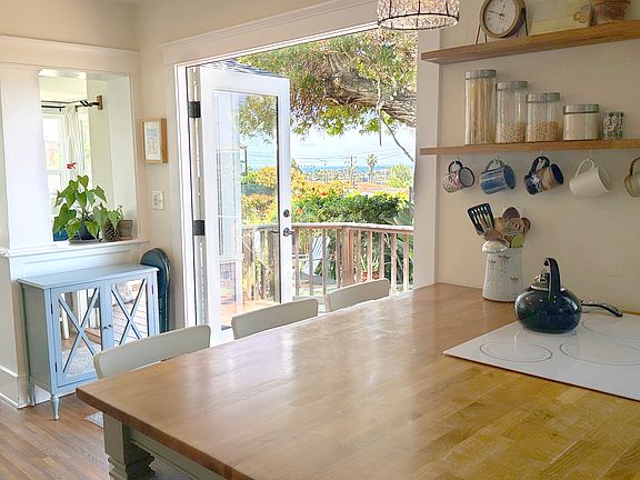 Kitchen/dining area with ocean views and French doors opening onto deck