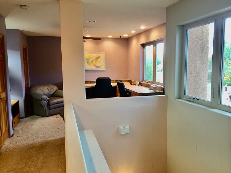 Upstairs home loft office with lots of counter space and closet storage.
