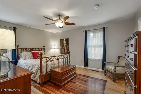 Master bedroom (on main level) with beautiful detail in the hardwood floor.