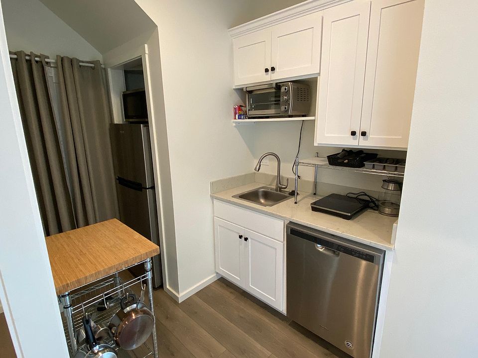 Kitchenette with dish washer, small oven and induction cook top, fridge, freezer.