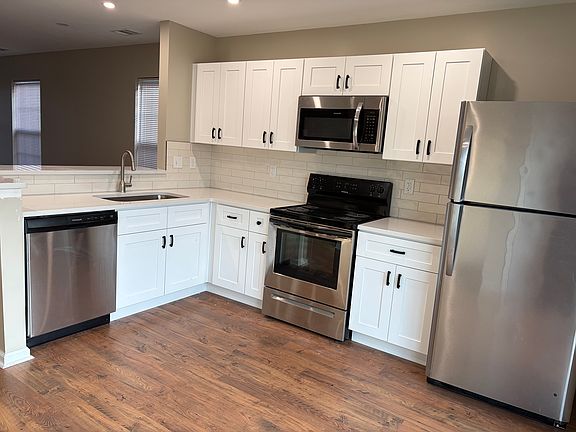 Newly updated kitchen with quartz countertops and stainless steel appliances.
