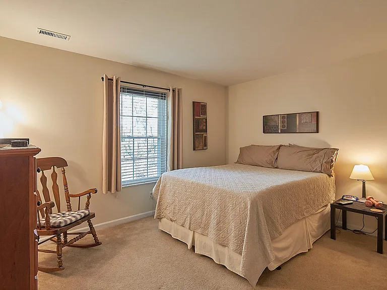 Master bedroom with large mirrored closet.