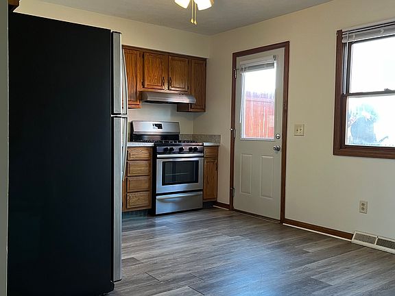 Oversized kitchen with stainless steel appliances (refrigerator, dish washer, range/oven)