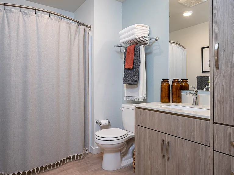 The Byway | Model #105 Bathroom Boasts Plenty of Storage and Curved Shower Rod