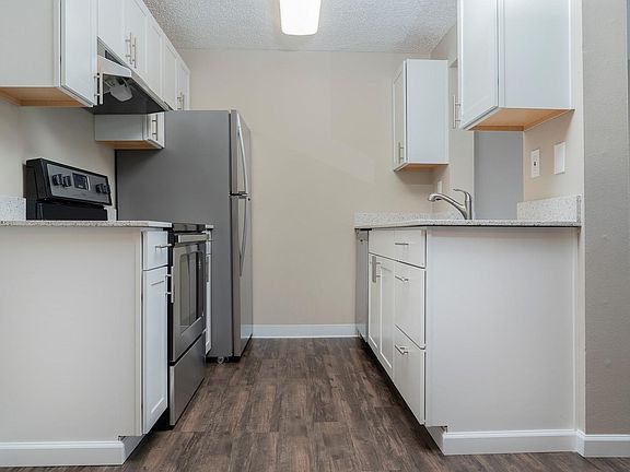 Kitchens have NEW white, shaker-style cabinets.