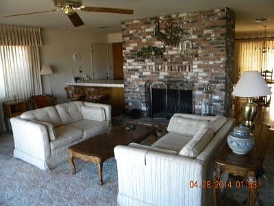 living room with warm brick fireplace