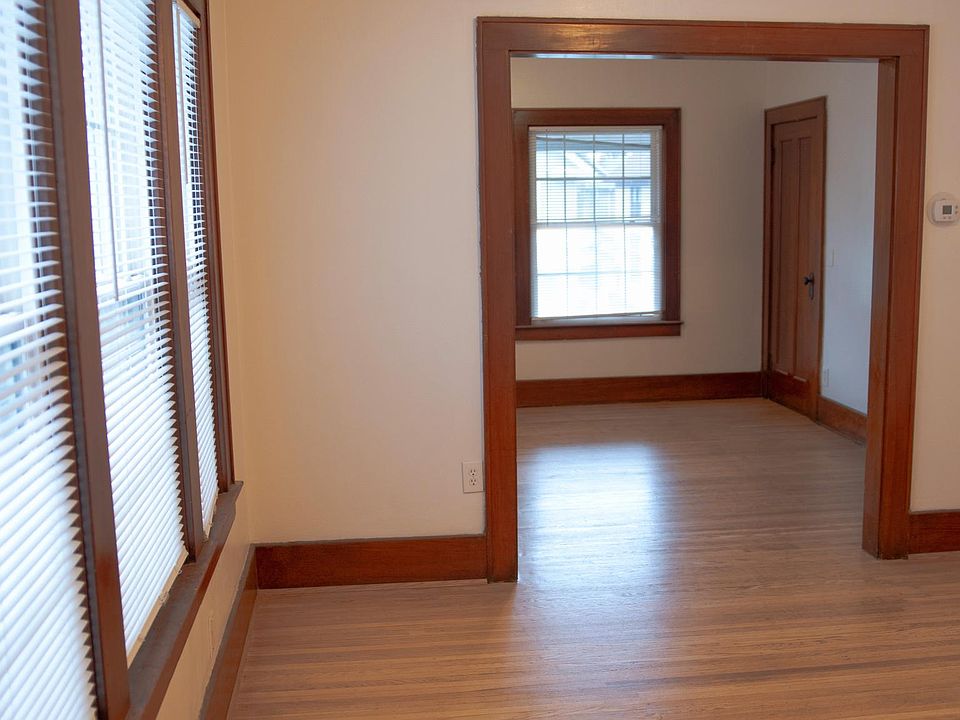 Living room and dining room w/ new blinds, fresh paint and refinish flooring.