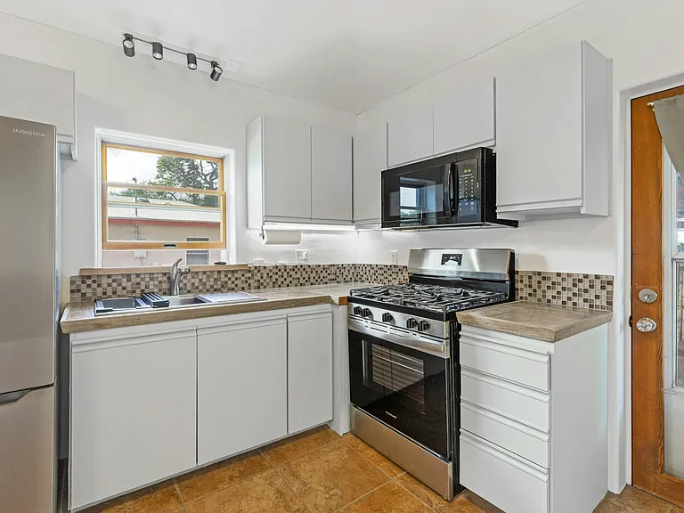 Kitchen with new appliances and plenty of light.