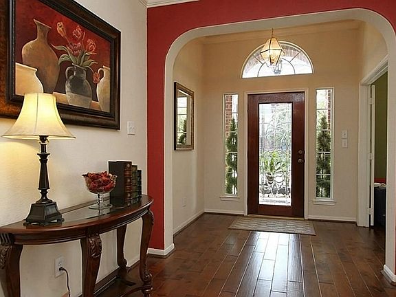 Spacious entry with real hand scraped wood floors that run through the study, entry, dining room, family room and hallway.