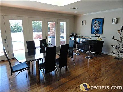 Dining room with sky light and large windows with backyard view