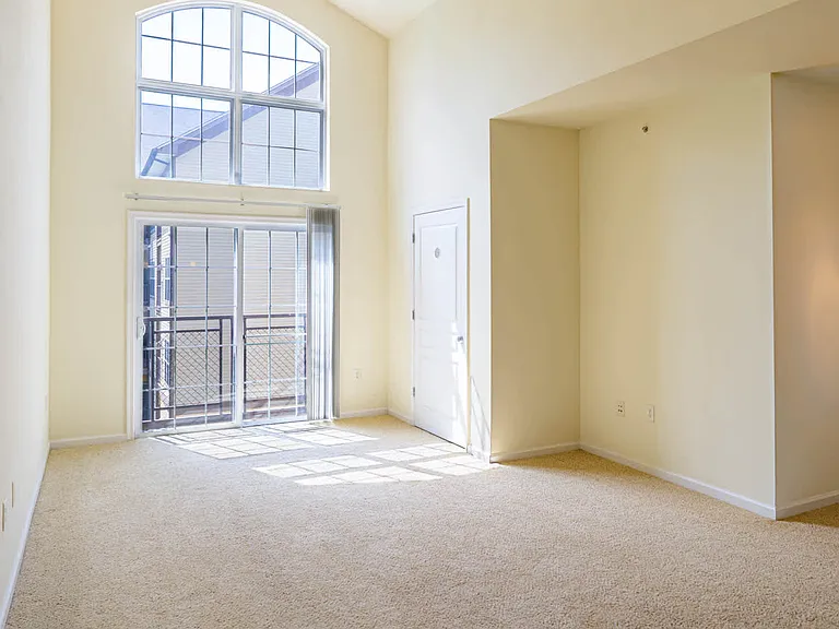 Carpeted Living Room with Balcony