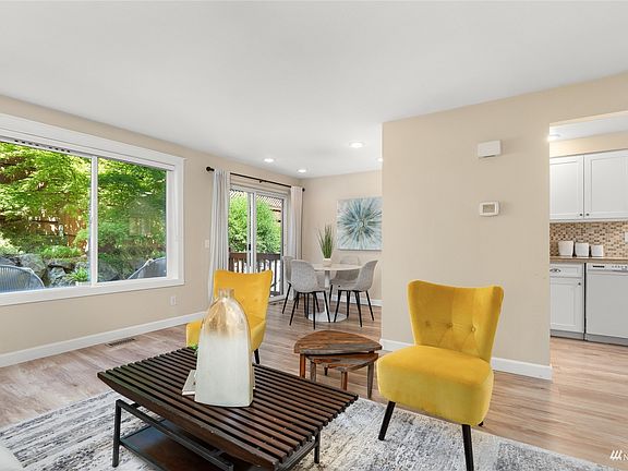  Living room with wood-wrapped natural gas fireplace is a connector to the spacious dining area. >