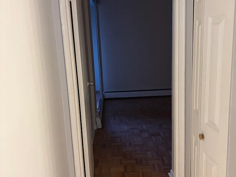 The hallway connecting the living room and leading to the bedroom