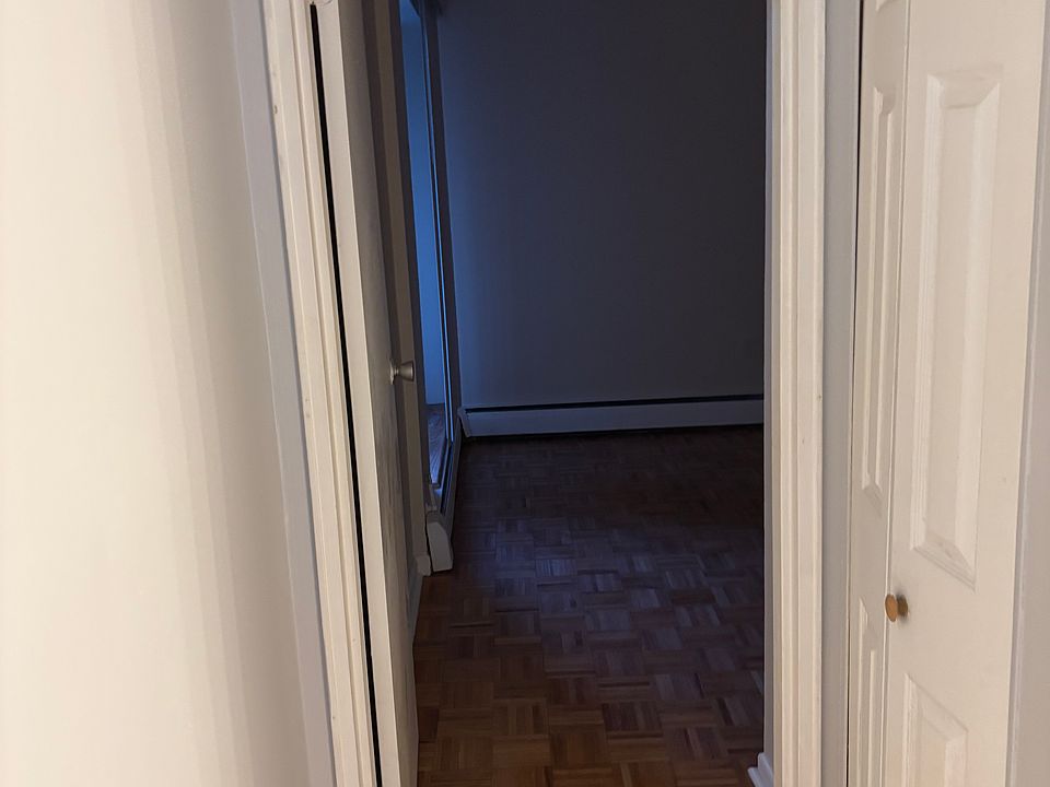 The hallway connecting the living room and leading to the bedroom
