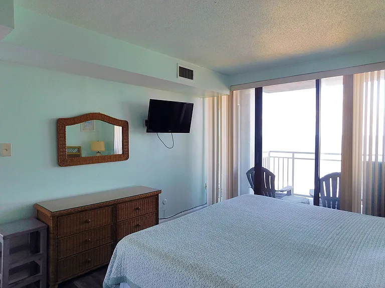 Main bedroom. King bed with sliding glass doors leading to balcony