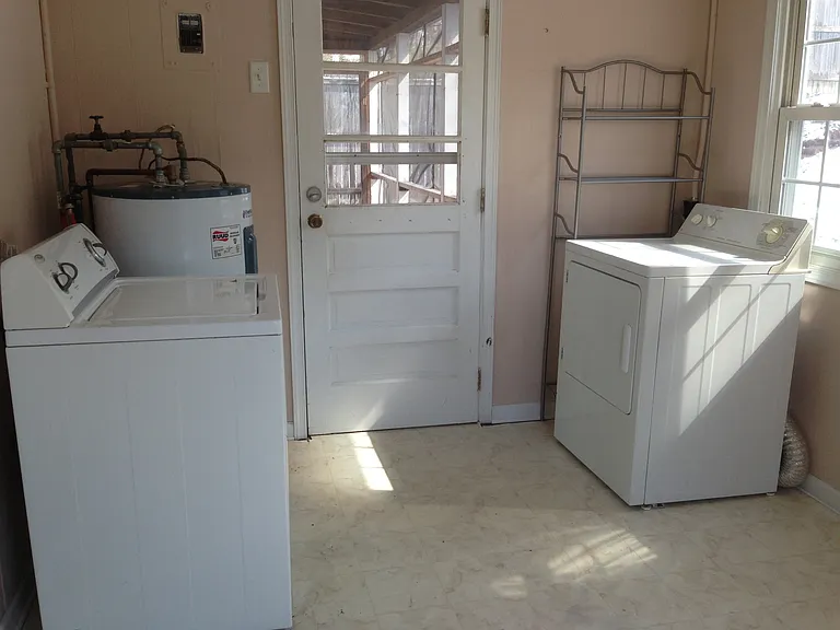 utility room, with washer and dryer. Backdoor to back patio.