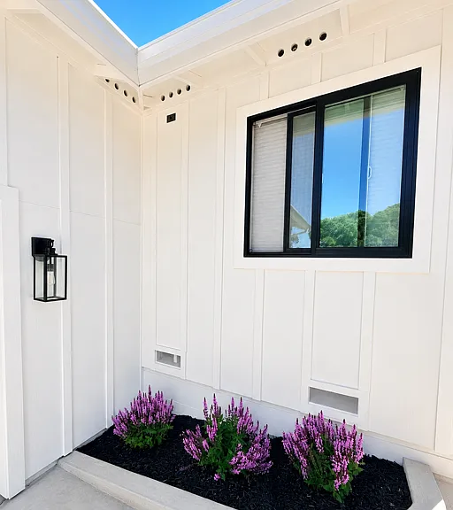 Professionally landscaped exterior with modern finishes and low-maintenance planting beds.