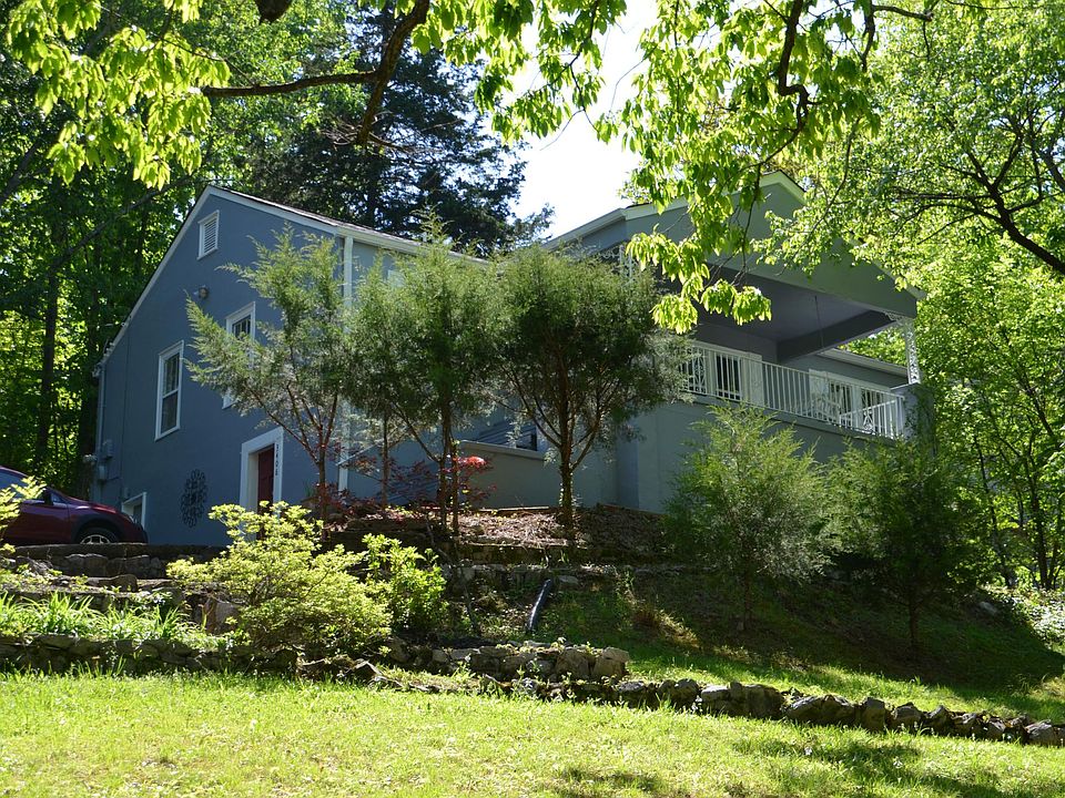 Front view of property from bottom of drive way. It's at least 10 degrees cooler under the two giant oaks. Moss yard ya'll!