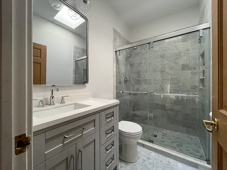 Newer gut-rehabbed primary bath with marble throughout.