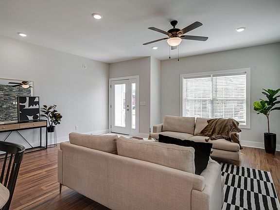 Warm living room, abundant natural light, luxurious high ceilings, open floor plan