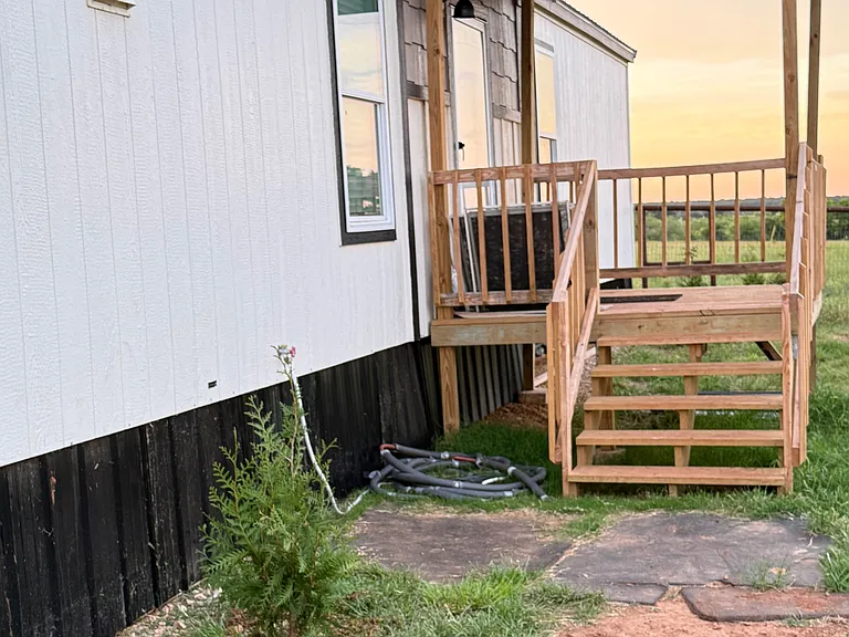 Covered porch entering front door. Currently working on landscaping.