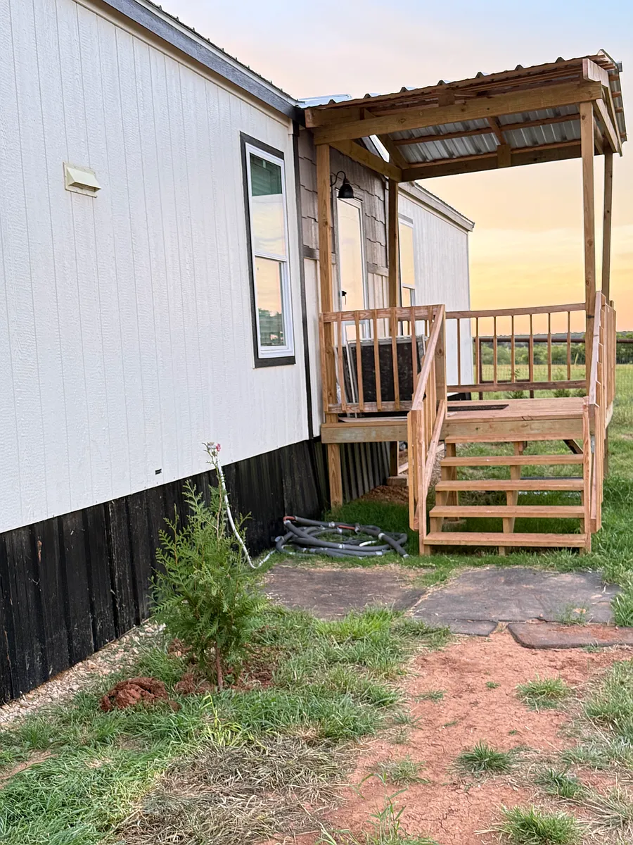 Covered porch entering front door. Currently working on landscaping. - 400 Dyer Rd